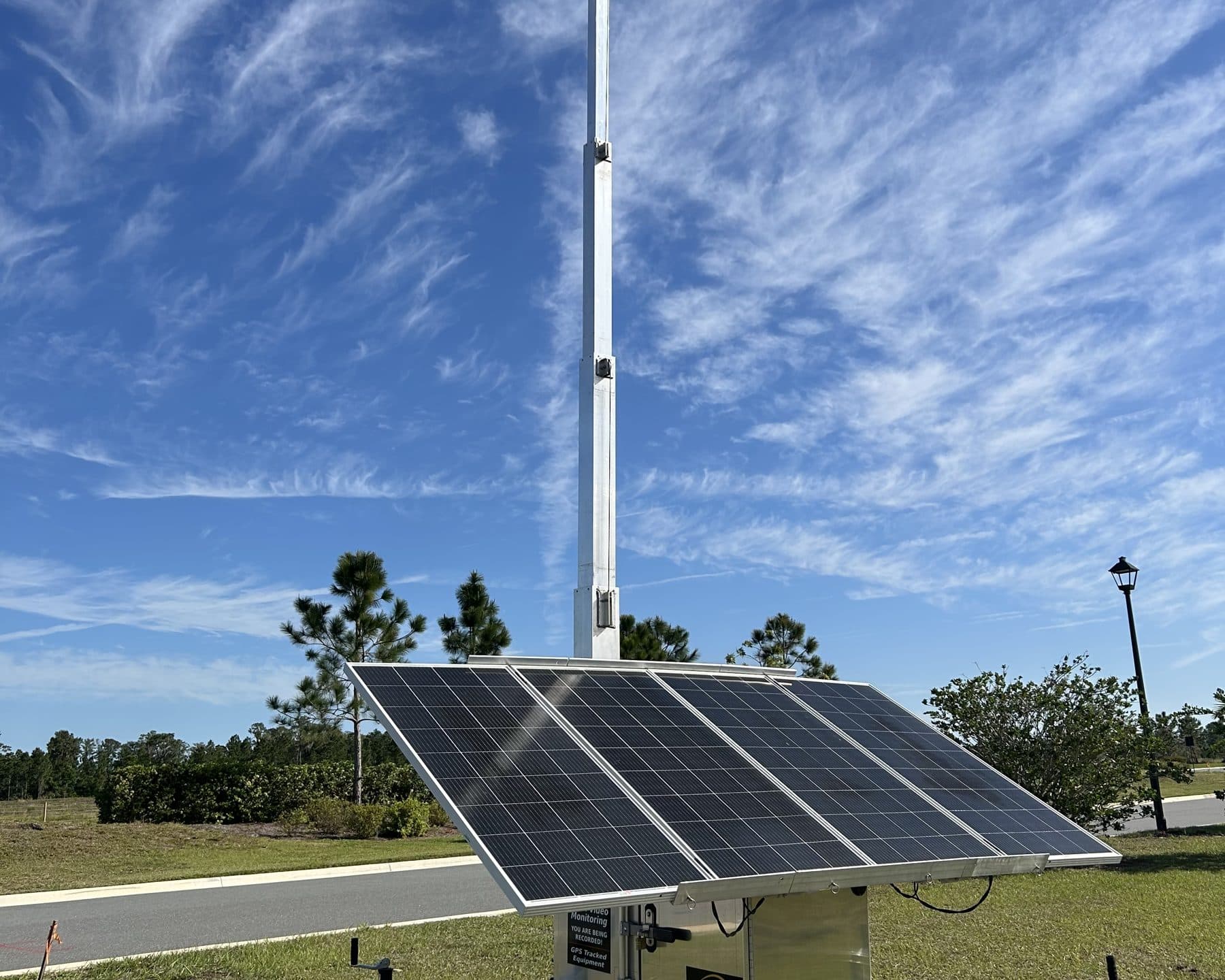 SolarCam360 solar surveillance unit deployed on open field terrain