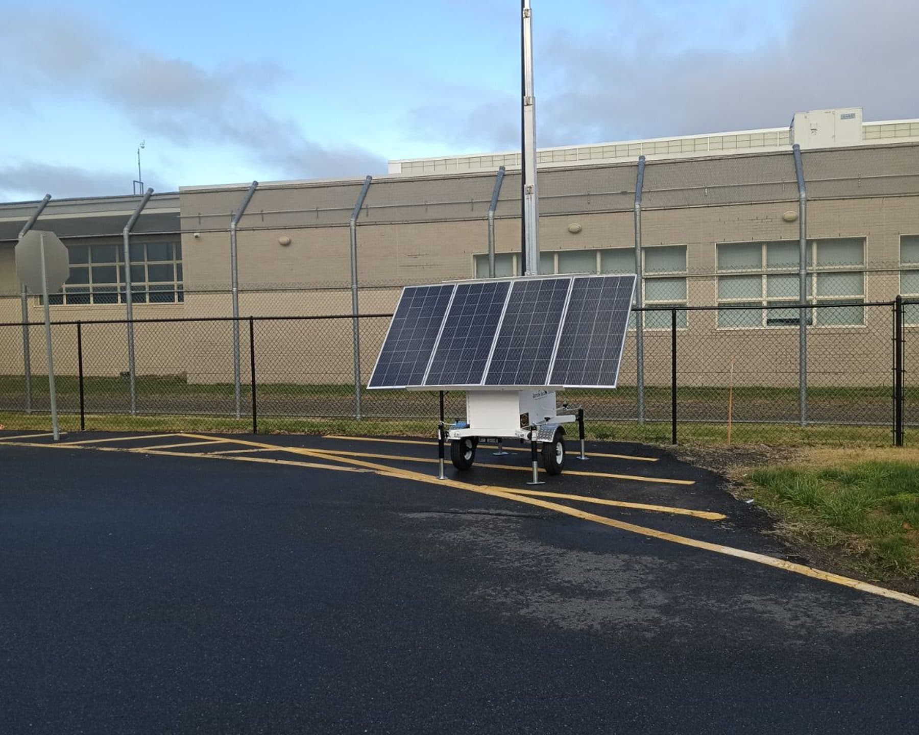 SolarCam360 solar surveillance trailer parked outside a fenced public facility