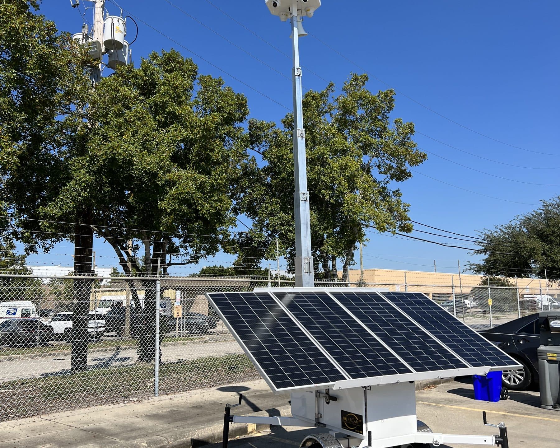SolarCam360 surveillance trailer covering a retail plaza parking field