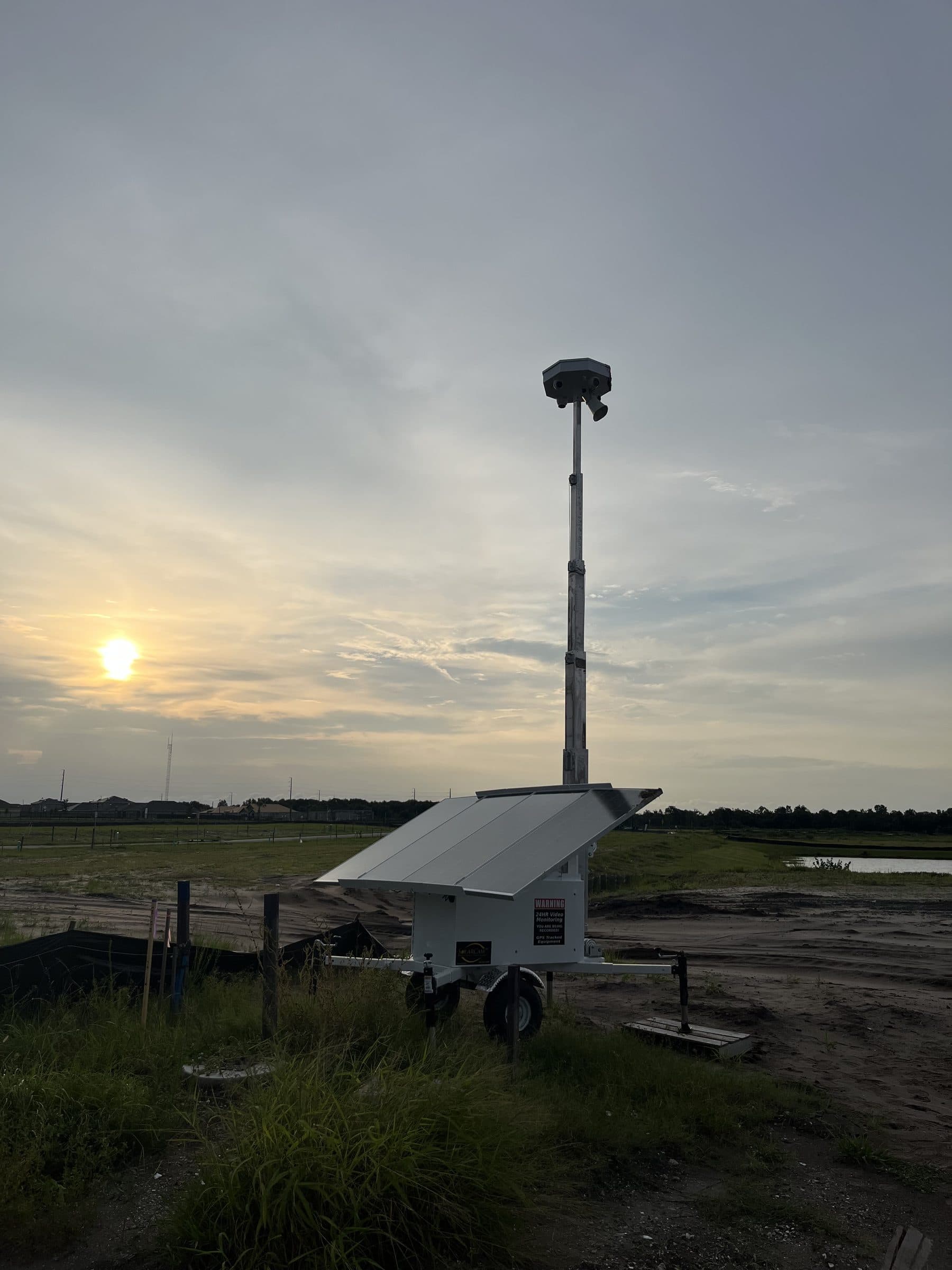 SolarCam360 unit deployed over open farmland at sunset